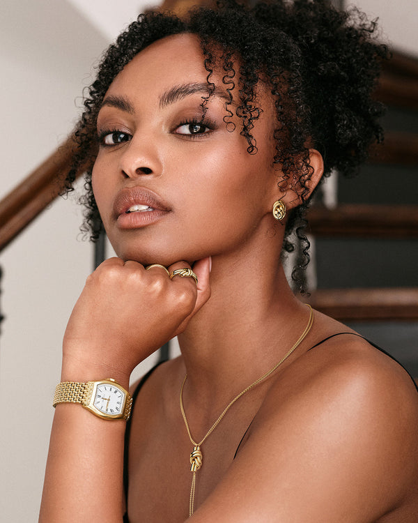 Earrings in gold plated-316L stainless steel from Waldor & Co. The model is Dual Knot Earring Polished.