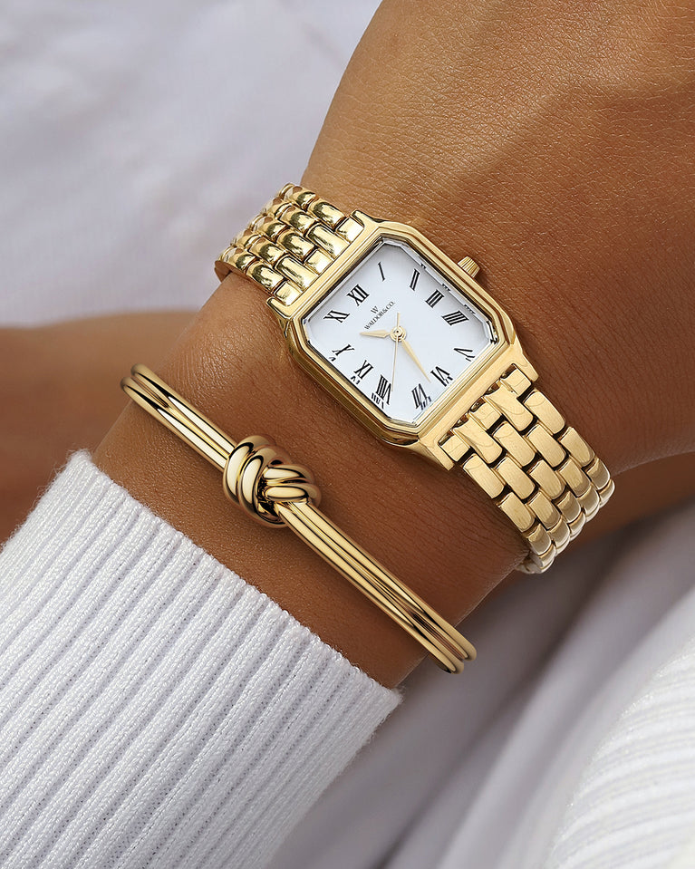 A square womens watch in 22k gold from Waldor & Co. with white Diamond Cut Sapphire Crystal glass dial. Seiko movement. The model is Eternal 22 Bellagio.