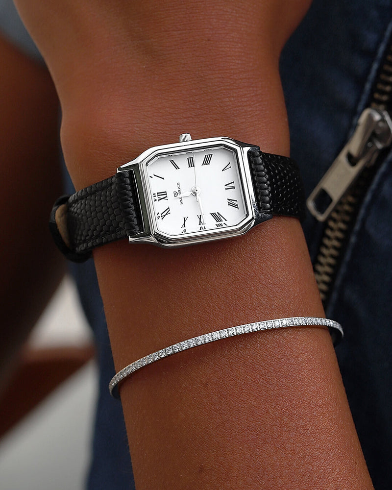 A square womens watch in Rhodium-plated 316L stainless steel from Waldor & Co. with white Diamond Cut Sapphire Crystal glass dial. Strap in black Genuine leather. Seiko movement. The model is Eternal 22 Varenna. 