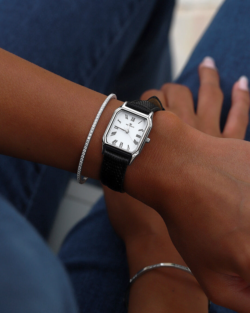 A square womens watch in Rhodium-plated 316L stainless steel from Waldor & Co. with white Diamond Cut Sapphire Crystal glass dial. Strap in black Genuine leather. Seiko movement. The model is Eternal 22 Varenna. 