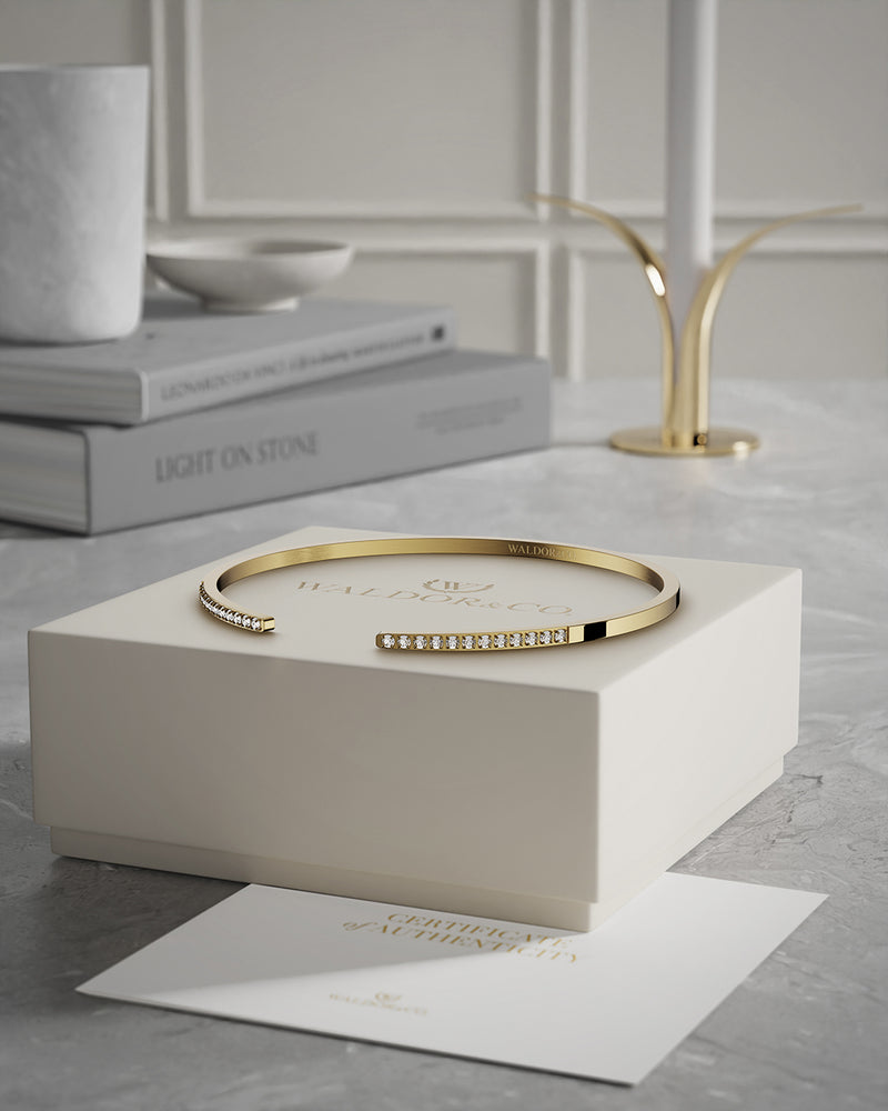 A Bangle in 14k gold plated 316L stainless steel from Waldor & Co. One size. The model is Acme Bangle Polished.
