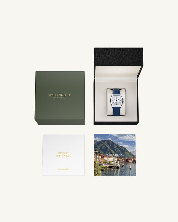 A square mens watch in Rhodium-plated 316L stainless steel from Waldor & Co. with white dial. Blue sailcloth strap. Ronda movement. The model is Constant 40 Tremezzo 37x45mm.