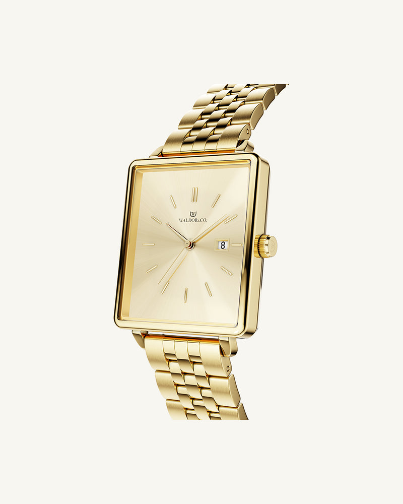 A square womens watch in silver and 14k gold from Waldor & Co. with gold sunray dial and a second hand. Seiko movement. The model is Delight 32 Chelsea 28x32mm.