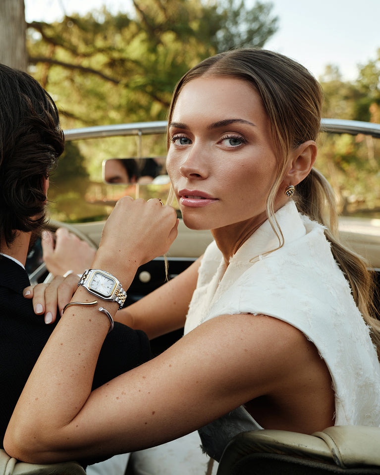  A square womens watch in silver and 14k gold from Waldor & Co. with silver sunray dial and a second hand. Seiko movement. The model is Delight 32 Chelsea 28x32mm.