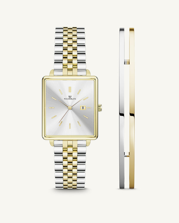 A square womens watch in silver and 14k gold from Waldor & Co. with silver sunray dial and a second hand. Seiko movement. The model is Delight 32 Chelsea 28x32mm.
