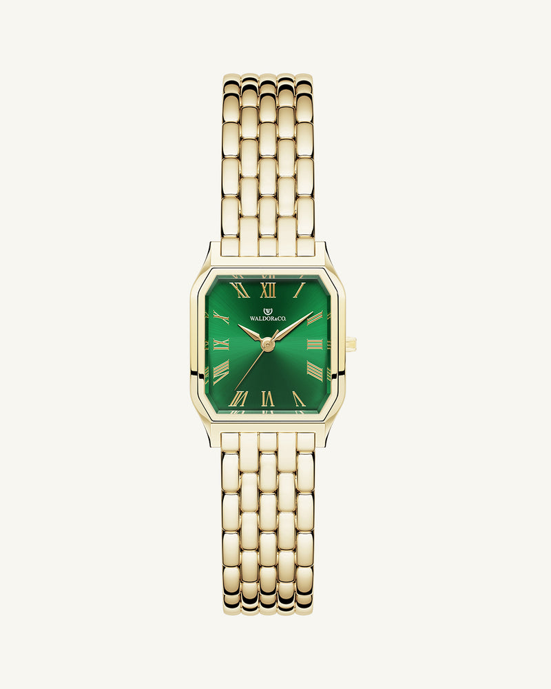 A square womens watch in 22k gold from Waldor & Co. with green Diamond Cut Sapphire Crystal glass dial. Seiko movement. The model is Eternal 22 Bellagio.