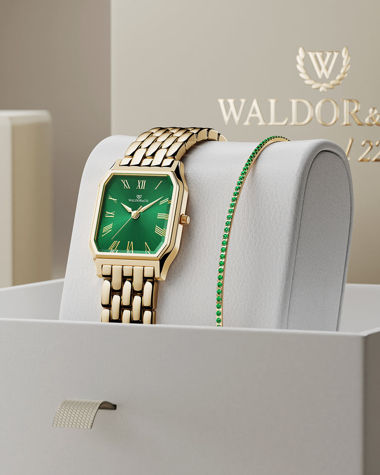 A square womens watch in 22k gold from Waldor & Co. with green Diamond Cut Sapphire Crystal glass dial. Seiko movement. The model is Eternal 22 Bellagio.