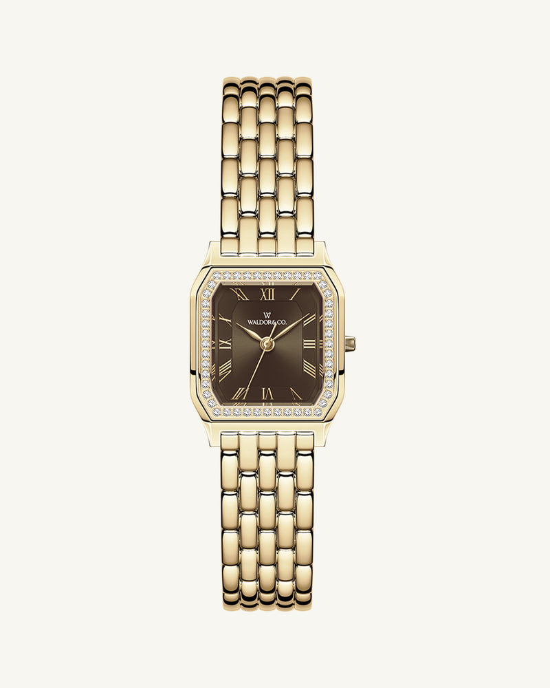 A square womens watch in Rhodium-plated 316L stainless steel from Waldor & Co. with a deep brown dial. Bezel with premium crystals. Diamond Cut Sapphire Crystal glass dial. Seiko movement. The model is Eternal 22 Bellagio Pavè.