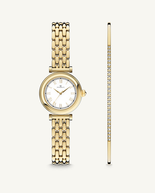 A round womens watch in 22k gold plated 316L stainless steel from Waldor & Co. with white Sapphire Crystal glass dial. Seiko movement. The model is Venia 24 Villefranche.