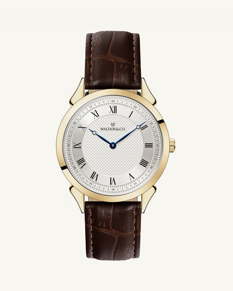 A round watch in gold from Waldor & Co. with white sunray patterned dial. Ronda movement. The model is Original 40 Côte d'Azur 40mm.