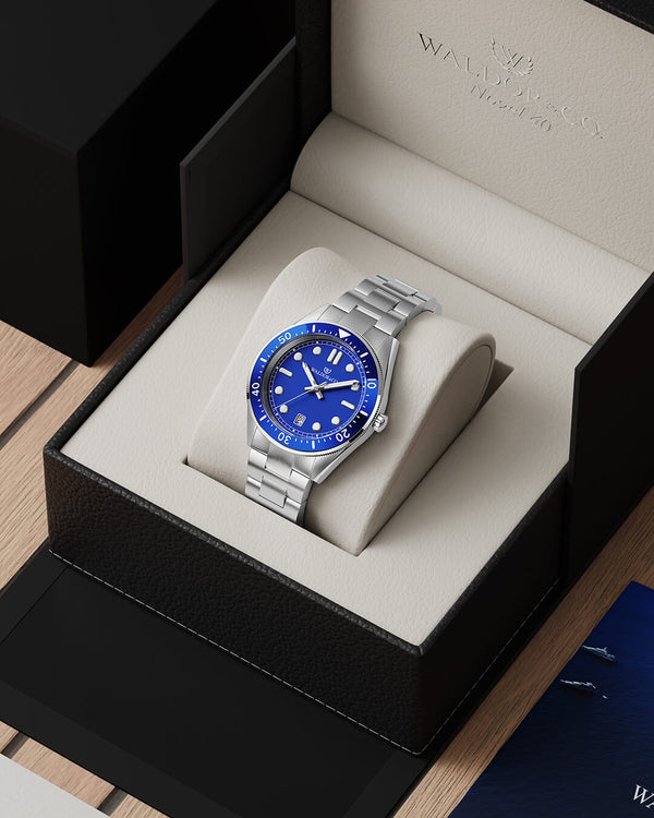 lifestyle_image,A round mens watch in Rhodium-plated 316L stainless steel from Waldor & Co. with Blue dial in brass with a rotating bezel. Applied indices, luminous hands. Ronda 715. The model is Novel 40 Cap d’Ail 40mm.